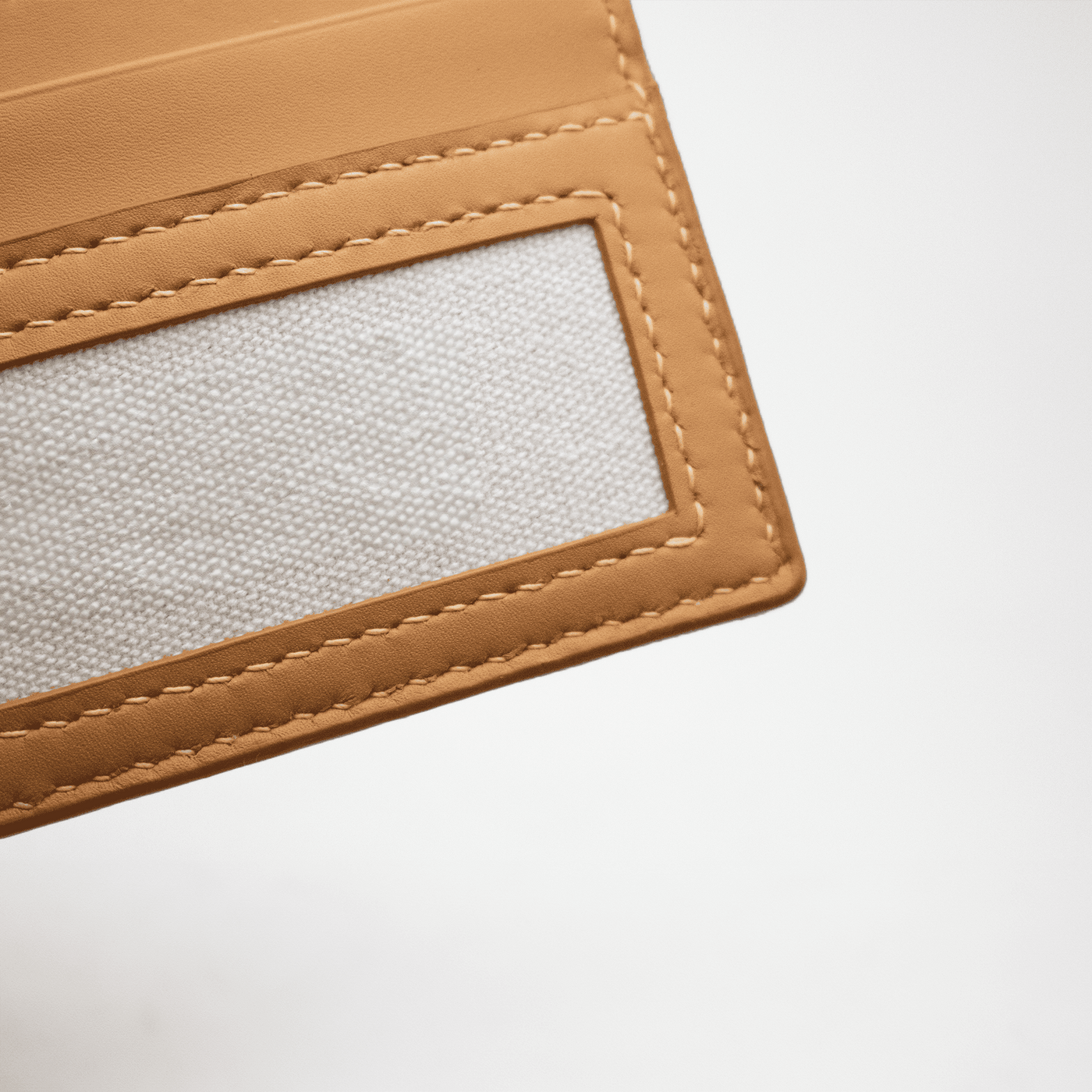 Broderie sur l'avant du porte-cartes en cuir, avec surpiqure en tons sur tons