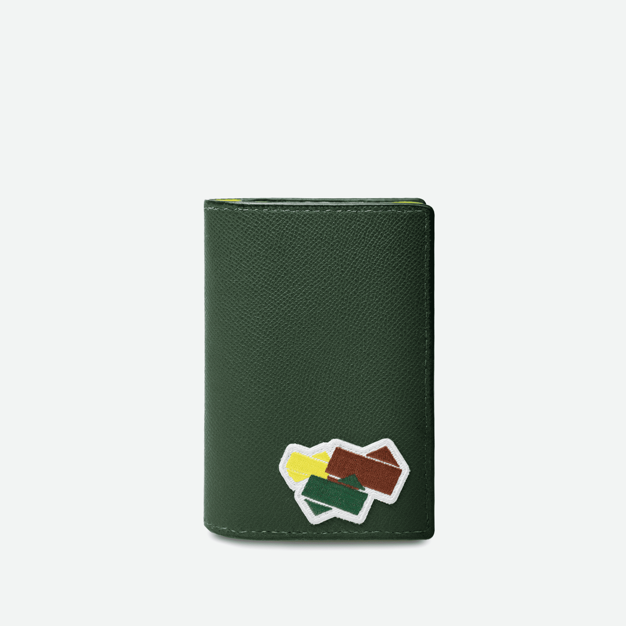 Couverture de passeport en cuir grainé de la collection Tennis. Logo brodé sur un patch à l'avant de la petite maroquinerie. 