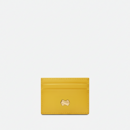 Façade avant du porte-cartes jaune avec logo signature Faubret en métal, design luxueux et intemporel.
